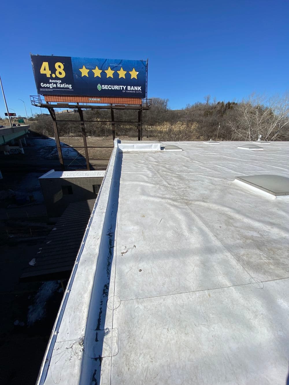 Billboard advertising Security Bank's 4.8 Google rating above a flat roof on a clear day.